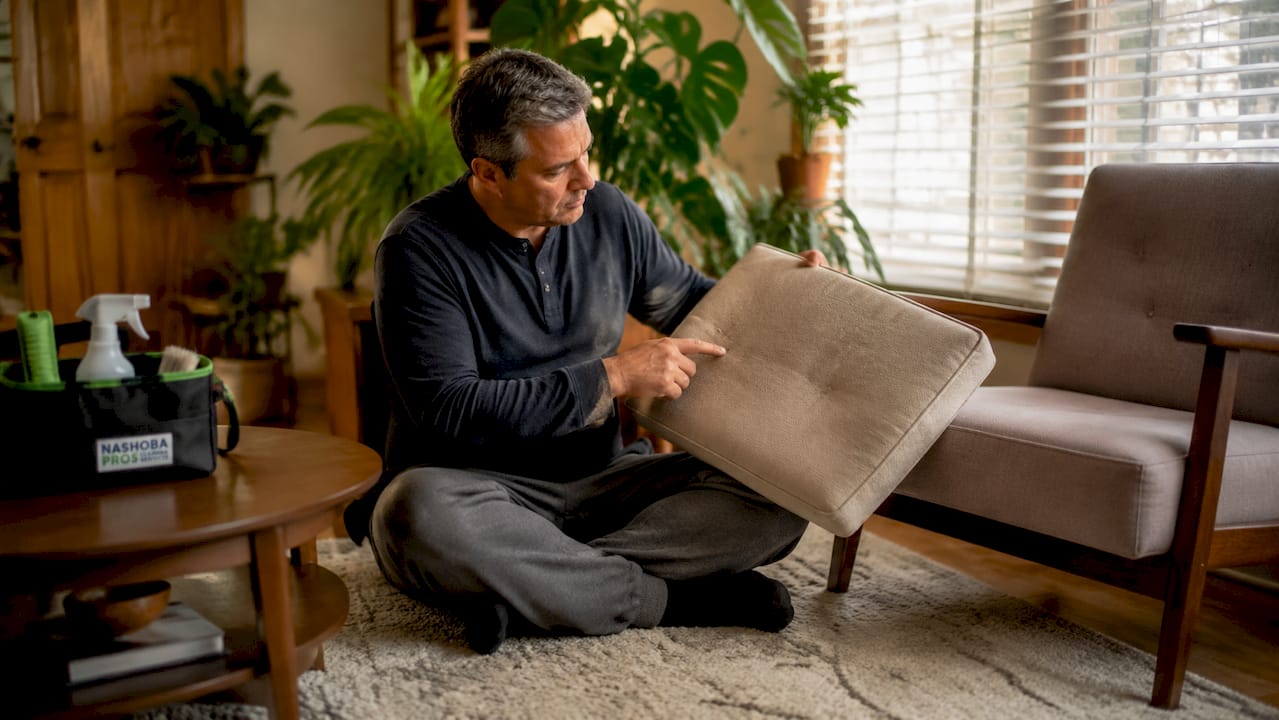 Homeowner inspecting faded upholstery fabric